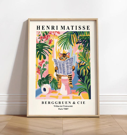 Framed Henri Matisse art print of a tabby cat reading a newspaper in a tropical setting.