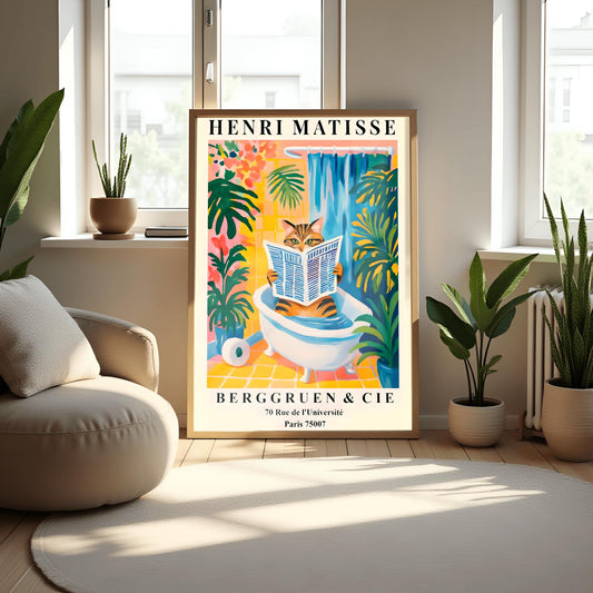 Framed Henri Matisse funny cat poster in a modern living room with plants and a chair.