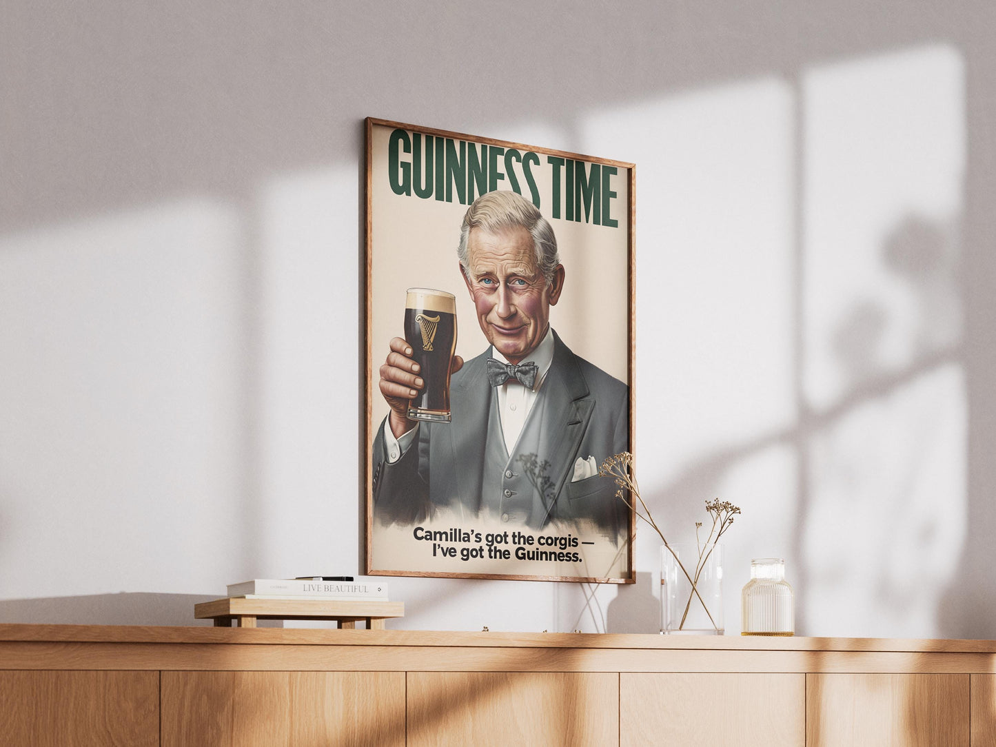 A humorous art print featuring King Charles III holding a classic pint of Guinness. The illustration shows him smiling with the iconic dark stout and creamy head. The text 'GUINNESS TIME' appears at the top, and 'Camilla's got the corgis — I've got the Guinness.' at the bottom, adding a witty royal touch. This unique print is ideal for pub or bar decor, a man cave, or as a quirky gift for fans of the British Royal Family and Guinness beer, blending humor with an iconic beverage