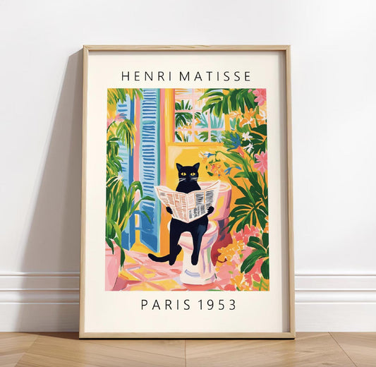 Framed artwork of a cat reading a newspaper in a colorful room by Henri Matisse, displayed on a white wall.
