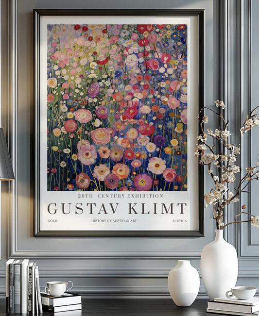 A promotional poster for an art exhibition features a vibrant and highly detailed painting of a dense field of flowers, rendered in the distinctive style of Gustav Klimt. The artwork, which dominates the upper portion of the poster, is a tapestry of various blossoms in shades of pink, red, white, yellow, and purple, set against a backdrop of deep blues and greens that suggest a distant landscape or sky.
