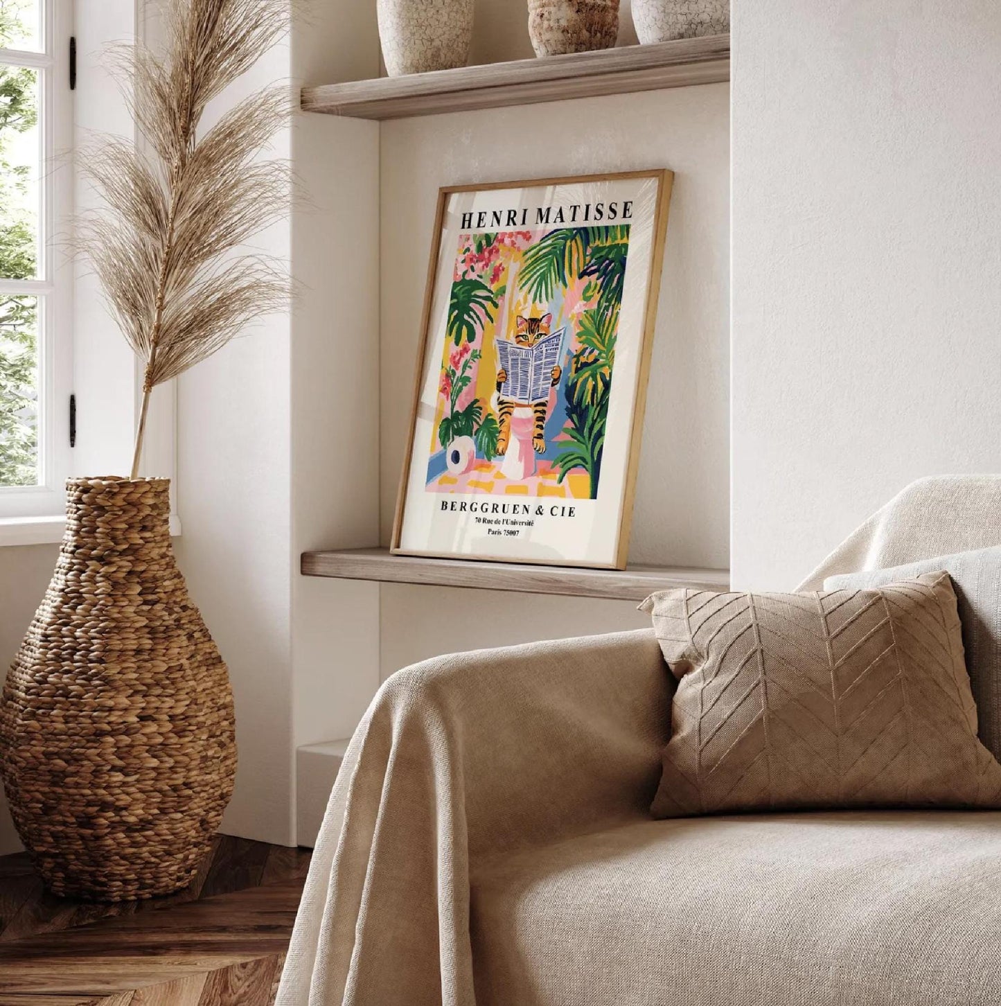 Framed Henri Matisse art print of a tabby cat reading a newspaper in a tropical setting.