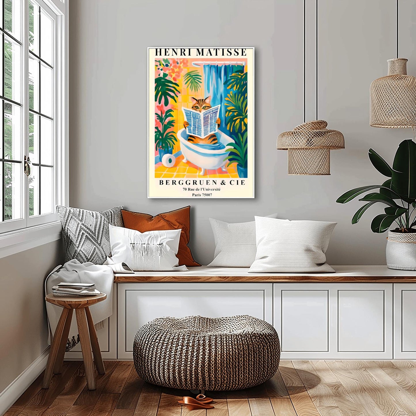 Living room with a funny Henri Matisse cat poster above a bench, surrounded by cushions and a plant.