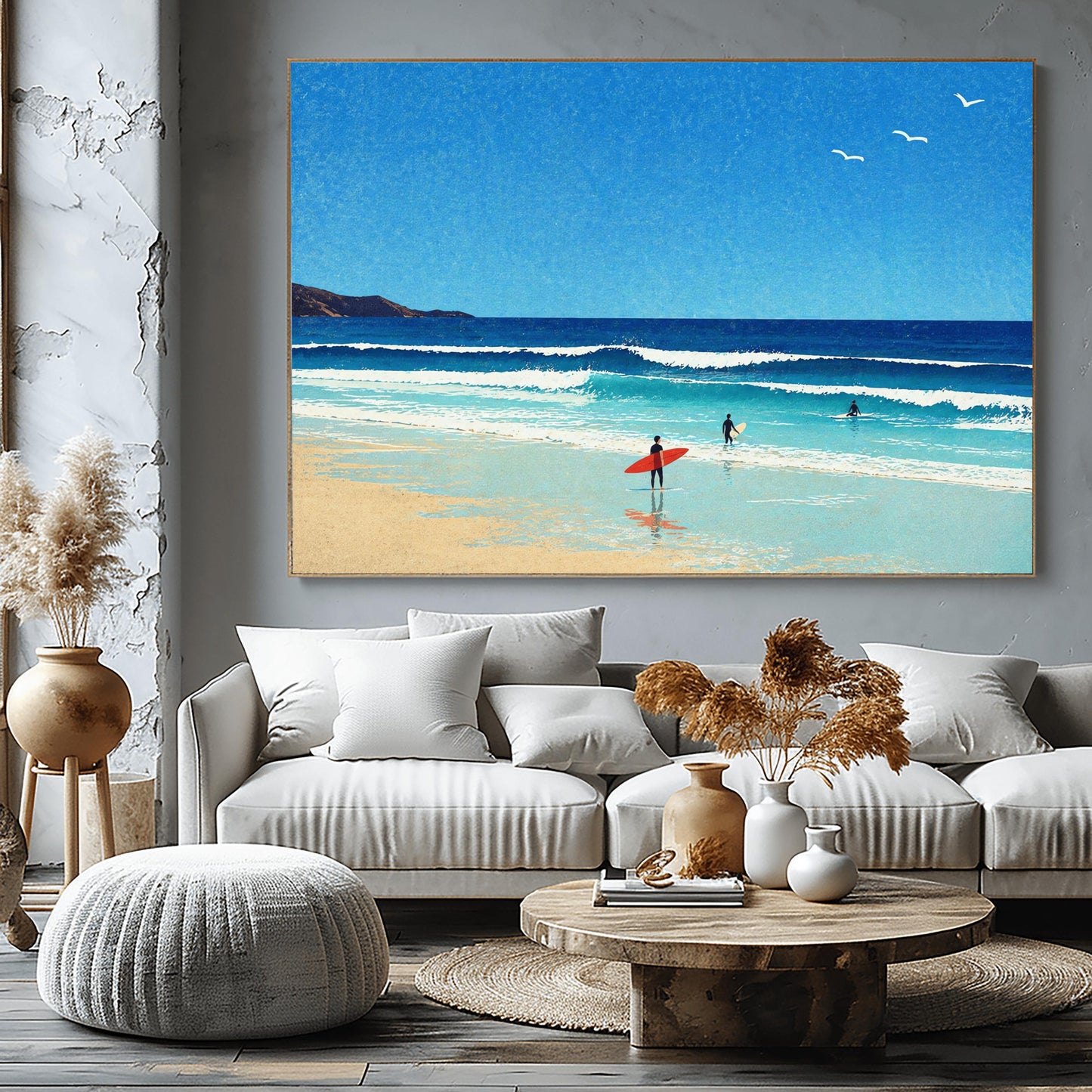 A horizontal minimalist art print of a bright beach day. A vast blue sky with three small white birds in flight sits above a turquoise ocean with gentle white waves. In the foreground, a sandy beach meets the water. A lone surfer in a black wetsuit holds a bright red surfboard on the shore, while two other surfers are further out in the water. A dark cliff is visible on the far left horizon. The style is clean and graphic with a subtle paper texture.