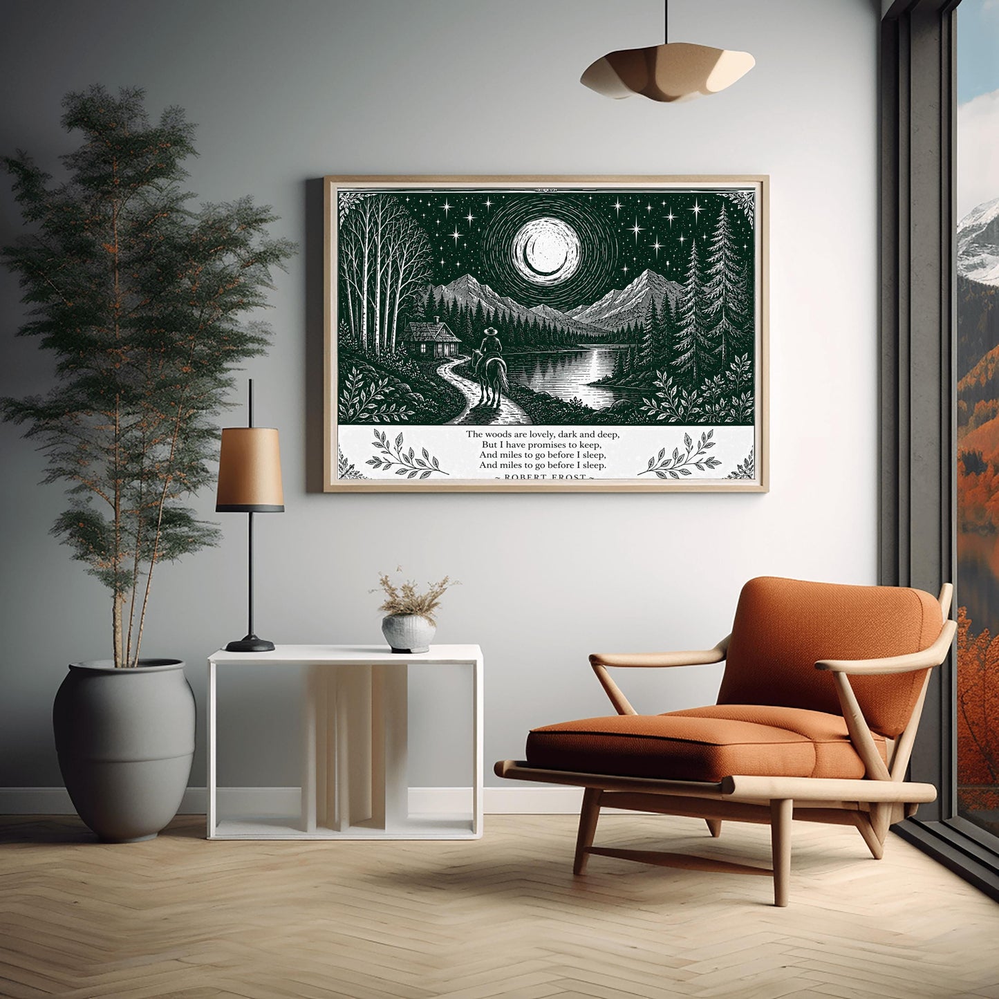 A wide horizontal art print in forest green and cream. A person on horseback follows a path toward a small cabin by a lake. In the background are tall pine forests and sharp mountain peaks under a massive moon and starry sky. The bottom of the print contains four lines of Robert Frost’s poetry in clean serif text, flanked by simple leaf illustrations.