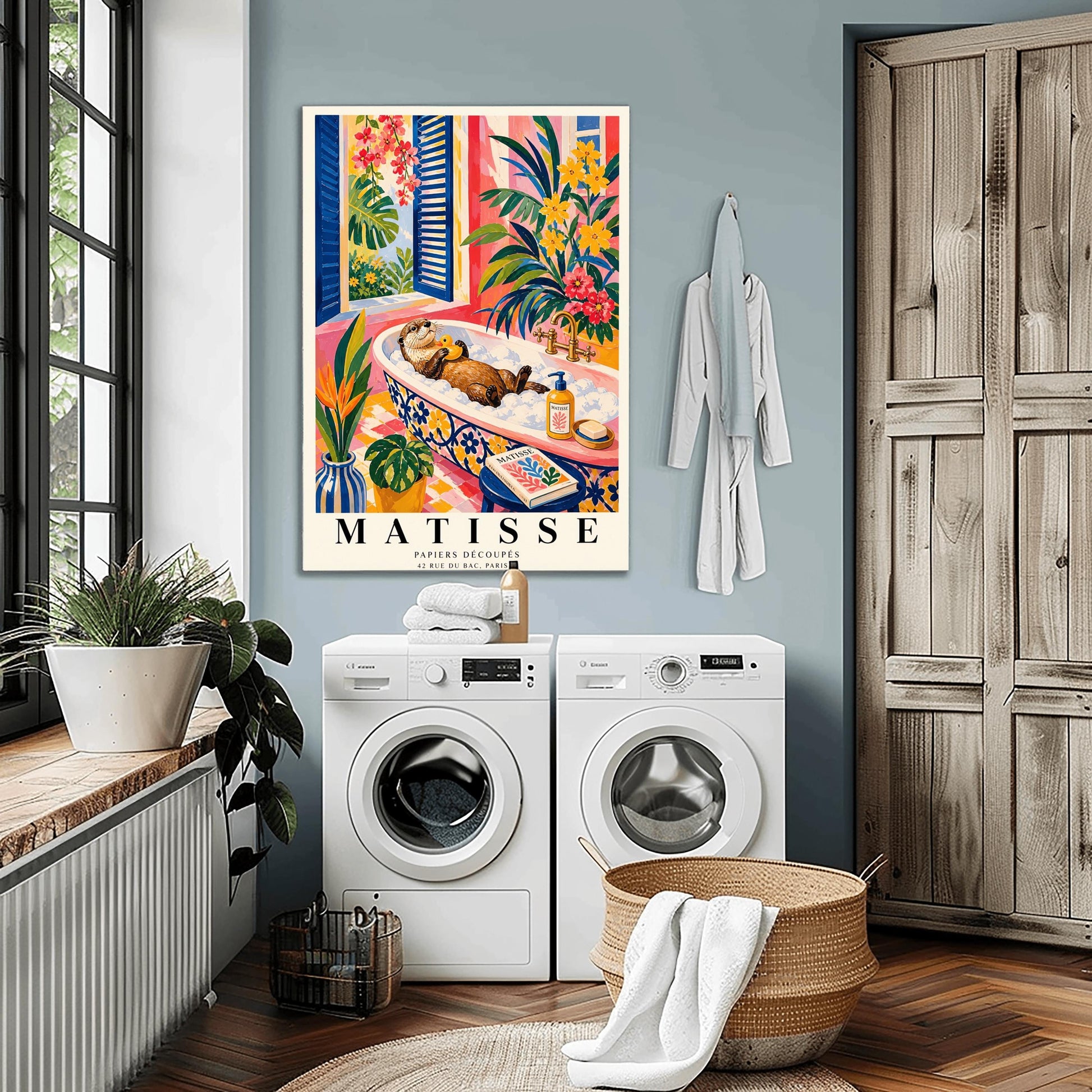 A vertical maximalist art print designed as a Henri Matisse exhibition poster. A brown otter floats on its back in a pink bubble bath, holding a small yellow rubber ducky. The bathtub has a blue and yellow floral pattern. The room is filled with vibrant tropical plants, pink walls, and yellow checkered tiles. A blue-shuttered window looks out onto a sunny garden. In the foreground, an art book and a striped vase are visible. Bold black text at the bottom reads "MATISSE PAPIERS DÉCOUPÉS"