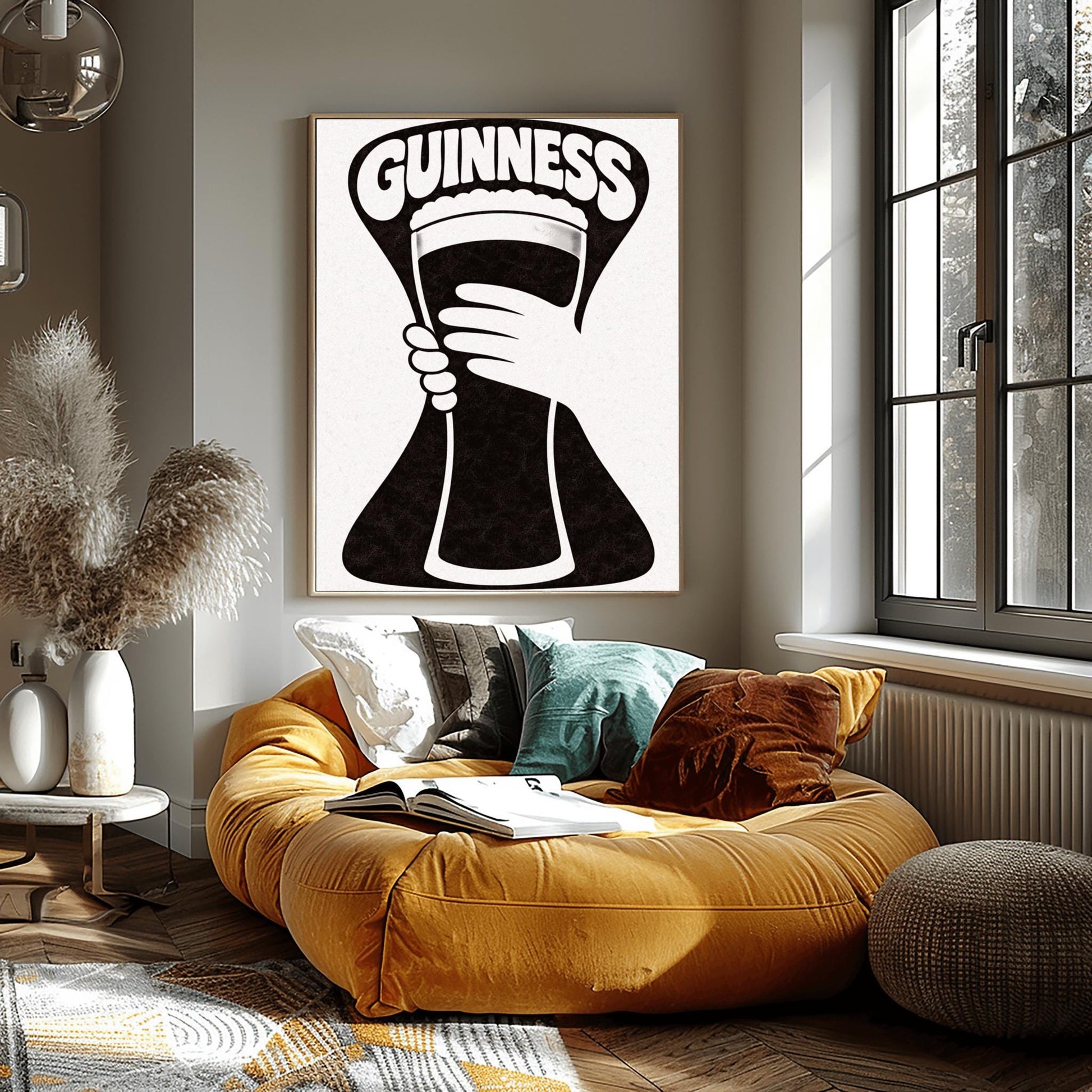 A vertical minimalist graphic in black and white. A large, black hourglass-shaped background features a white hand silhouette holding a pint glass made of negative space. The word "GUINNESS" is arched in bold white text at the top.