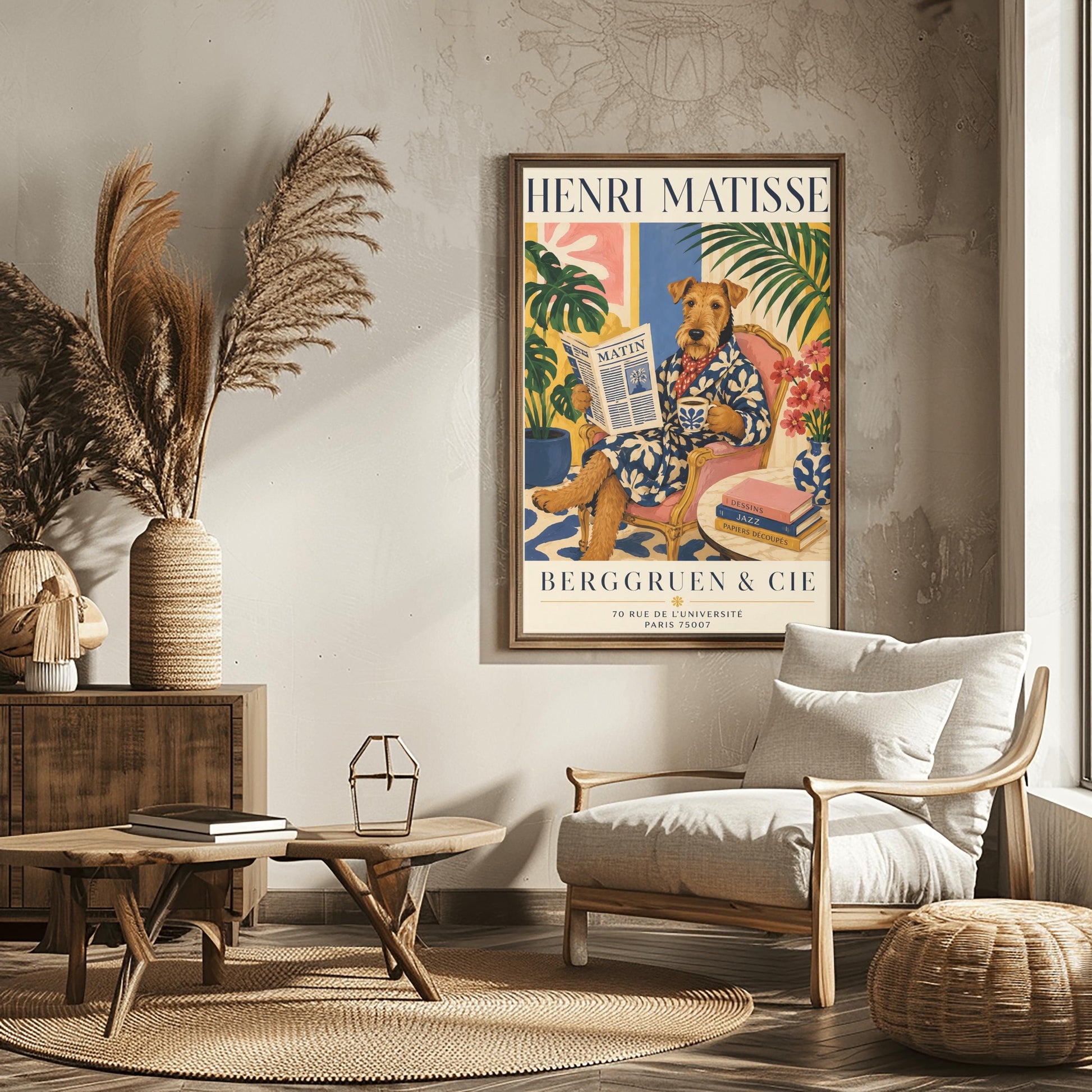 A vertical gallery exhibition poster with bold navy text reading "HENRI MATISSE" at the top and "BERGGRUEN & CIE" at the bottom. The illustration shows a brown scruffy terrier dog sitting like a human in a pink armchair with wooden frame, crossing its legs. The dog wears a navy blue robe with a white leaf pattern and a red and white polka dot scarf. It holds a coffee mug in one paw and a newspaper titled "MATIN" in the other.