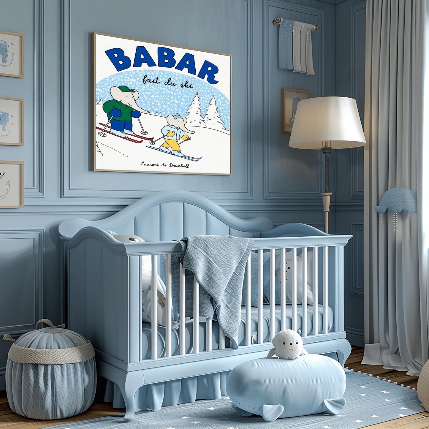 A horizontal children's art print featuring two cartoon elephants skiing down a white hill from left to right. The larger elephant, Babar, is in a green jacket with red skis. The smaller elephant is in a light blue jacket with blue skis. A large blue arch in the background represents a sky filled with white snow. Bold blue text at the top reads "BABAR" and script text below it says "fait du ski." The name "Laurent de Brunhoff" is centered at the bottom.