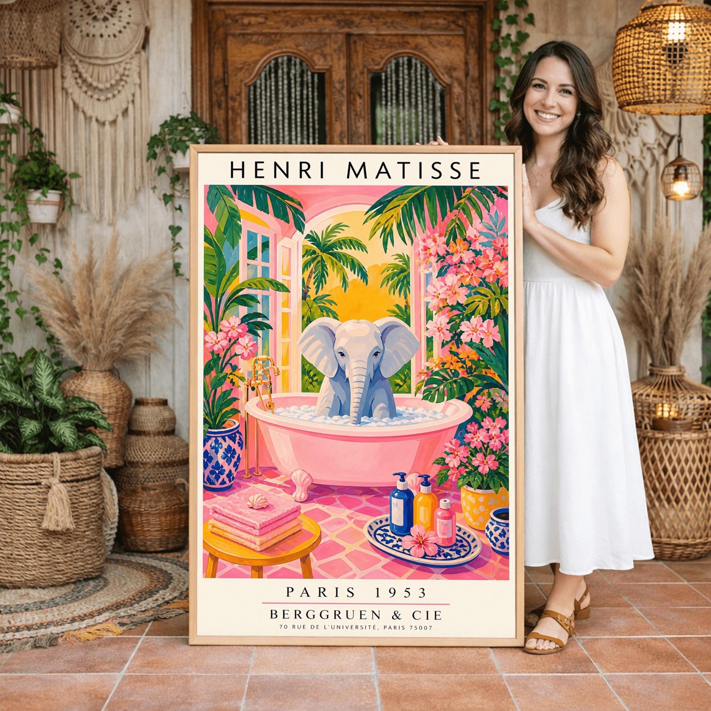 A vertical maximalist art print styled as a Henri Matisse exhibition poster. A light grey baby elephant is sitting in a large pink clawfoot bathtub filled with white bubbles. The bathroom features hot pink tiled floors, vibrant pink flowers, and lush green tropical plants. In the background, an arched window shows a bright golden sunset with palm tree silhouettes. A small yellow stool with towels and various blue and yellow ceramic vases decorate the room.