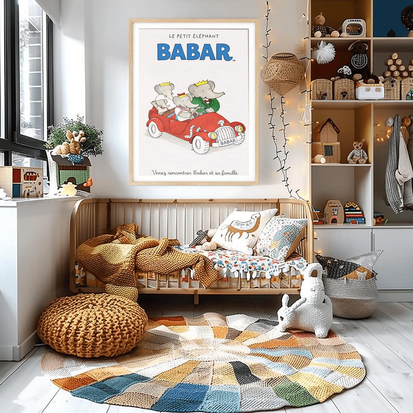 A vertical children's illustration poster. At the top, "LE PETIT ÉLÉPHANT" is written in small letters above the word "BABAR" in large blue block letters. In the center, four elephants are riding in a bright red vintage open-top convertible. A young elephant is driving, Babar is in the passenger seat in a green suit, and two smaller elephants are in the back. The car has a "BABAR" license plate. The text at the bottom says "Venez rencontrer Babar et sa famille."