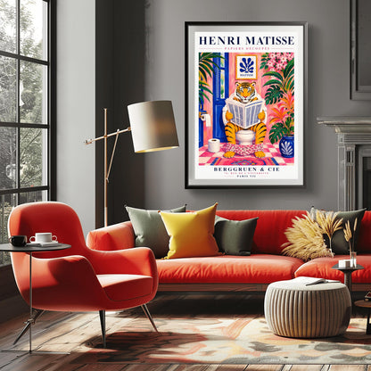 A vertical art print styled as a Henri Matisse exhibition poster. In the center, a tiger sits on a toilet in a pink bathroom, reading a newspaper with pink floral pants at its ankles. The room is decorated with lush tropical plants, a blue door, and a small Matisse-style blue cutout art piece on the wall. The text "HENRI MATISSE" is at the top, and "BERGGRUEN & CIE" is at the bottom.