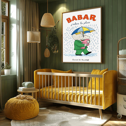 A vertical children's illustration poster titled "BABAR: j'adore la pluie" in orange and blue. King Babar, in a green suit and crown, is walking through the rain while holding a blue and yellow striped umbrella. He is carrying a small elephant wearing a pink rainsuit. They are walking through light blue puddles on a white background. The name "Laurent de Brunhoff" is at the bottom.