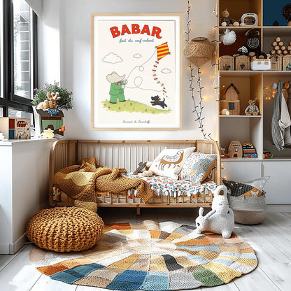 A vertical retro fine art exhibition poster titled "BABAR fait du cerf-volant" on a wide cream border. The top "BABAR" text is printed in a bold red font. The illustration shows an elephant in a green suit and red bowtie flying a red and yellow striped diamond kite on a green grassy hill with small flowers. A small black dog in a plaid scarf runs on the hill below, and the name "Laurent de Brunhoff" anchors the bottom.