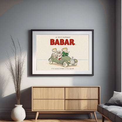 A horizontal illustration featuring Babar the Elephant and his family in a vintage sage-green roadster. Babar, wearing a green suit and crown, is driving. Beside him and in the back seat are his wife Celeste and three young elephants. The car is on a light sandy beach under a large red "BABAR" title. The background is a simple, pale cream sky with a thin blue ocean line. French text at the bottom reads, "À la rencontre de Babar et de sa famille."