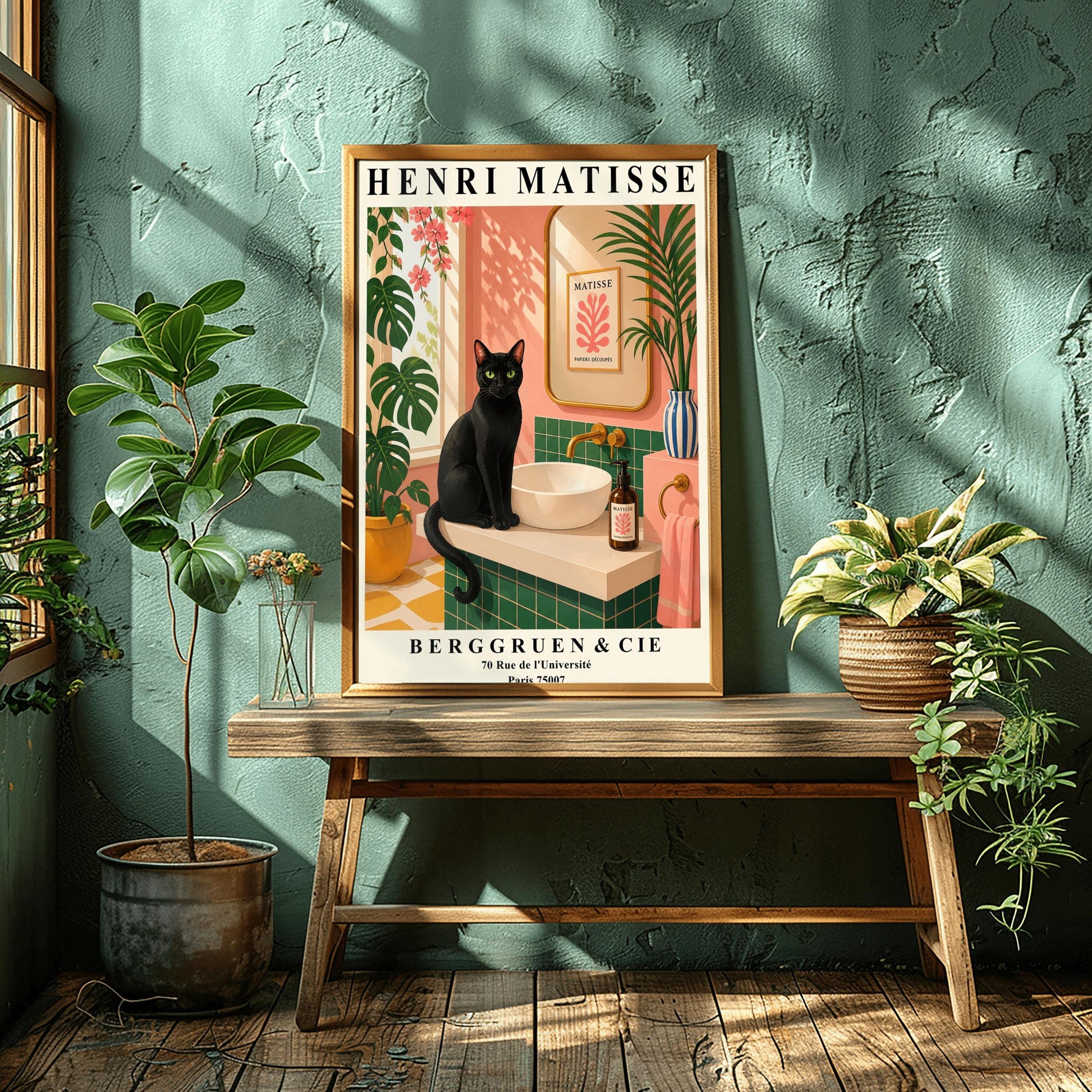 A vertical art print styled as a Henri Matisse exhibition poster. A sleek black cat with bright green eyes sits on a cream-colored bathroom vanity next to a white vessel sink. The bathroom features blush pink walls and emerald green tiles. A gold-framed mirror reflects a Matisse leaf print. Lush green plants and pink flowers frame the scene, and dappled sunlight creates shadows on the wall. The poster has bold black text at the top and bottom with the gallery name Berggruen & Cie.