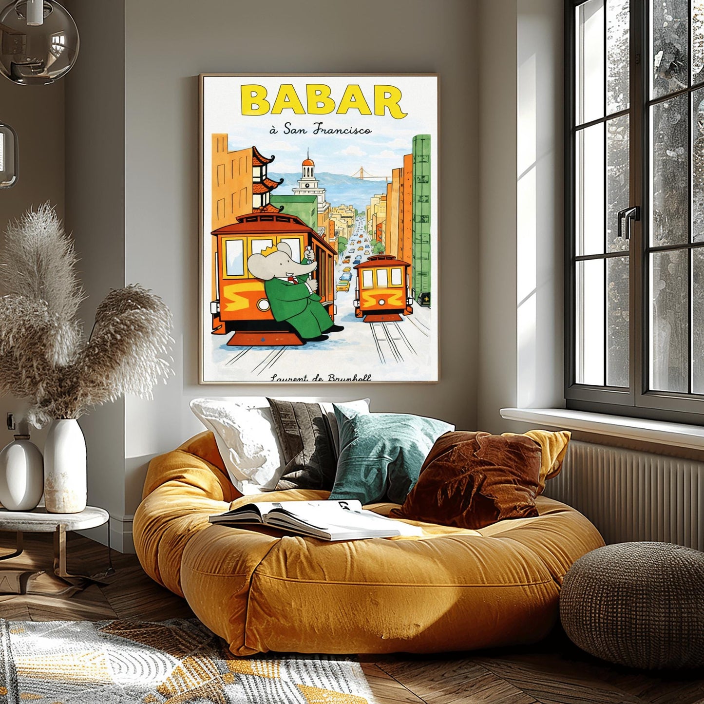 A vertical children's illustration poster titled "BABAR: j'adore la pluie" in orange and blue. King Babar, in a green suit and crown, is walking through the rain while holding a blue and yellow striped umbrella. He is carrying a small elephant wearing a pink rainsuit. They are walking through light blue puddles on a white background. The name "Laurent de Brunhoff" is at the bottom.