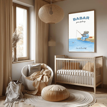 A vertical art print titled "BABAR goes fishing" in large blue letters. A grey elephant sits on a tan rocky pier overlooking blue water. He is wearing a blue and white checkered shirt, light blue overalls, and a white cap. He holds a thin fishing rod, and his line is in the water with a small red bobber. A red tackle box sits on the dock behind him. The name "Jean de Brunhoff" is at the bottom.