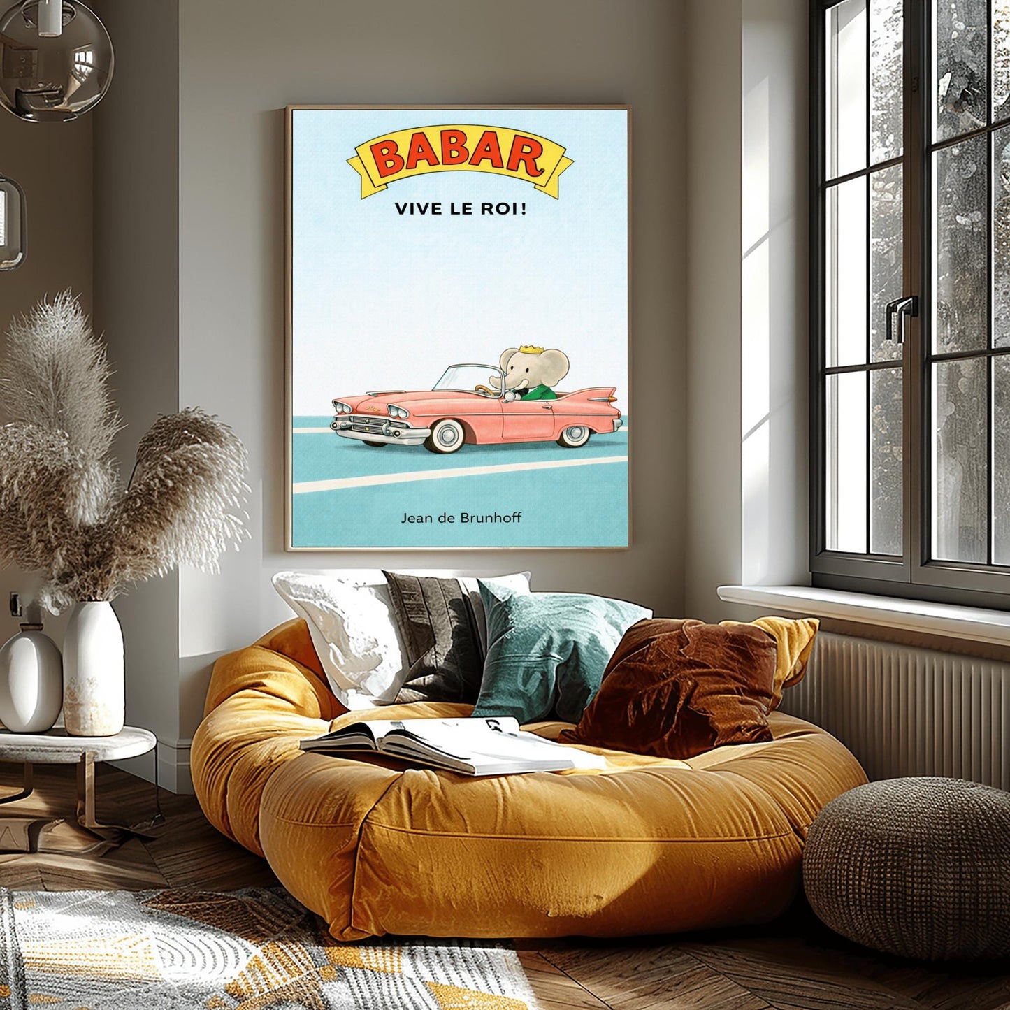 A vertical children's illustration poster. At the top, a yellow banner reads "BABAR" in red letters, with "VIVE LE ROI!" written in black below it. At the bottom, King Babar in a green suit and crown is driving a large, salmon-pink vintage convertible car with white tires. The car is on a simple blue road with white lines, and the background is a solid light blue sky. The name "Jean de Brunhoff" is at the bottom.
