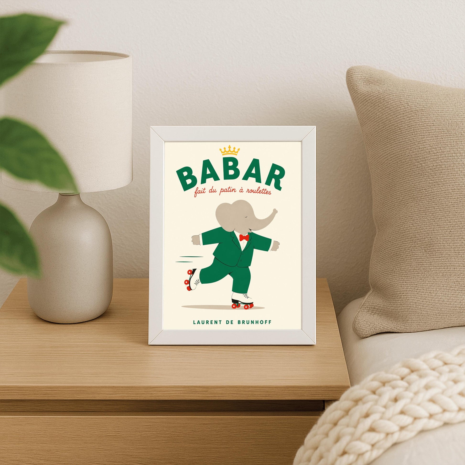 A vertical storybook-style art print of Babar the Elephant roller skating against a cream background. Babar is wearing his signature green suit and red bow tie. He is balanced on white roller skates with red wheels, with one foot lifted behind him. The top of the print features the word "BABAR" in large green letters above the red script text "fait du patin à roulettes" and a small gold crown. The name "LAURENT DE BRUNHOFF" is printed at the bottom.