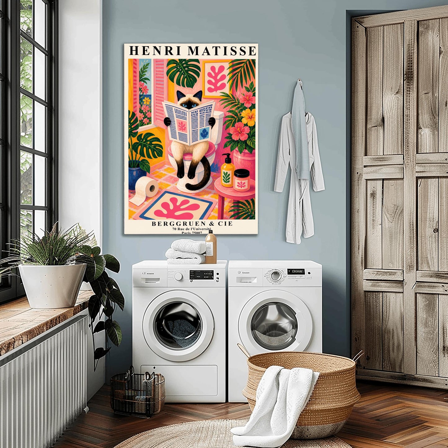 A vertical maximalist art print designed as a Henri Matisse exhibition poster. A cream-colored Siamese cat with dark brown points and blue eyes sits on a toilet, holding and reading a newspaper. The bathroom is vibrantly colored with pink walls, yellow and pink checkered tiles, and lush green monstera plants. A window with pink shutters looks out onto a blue sea. A pink bath mat with a leaf cut-out design and colorful soap jars add to the eclectic decor.