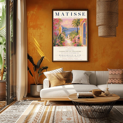A French exhibition poster titled "MATISSE" at the top, featuring a pastel-toned painting of a Mediterranean coastal scene. A pathway lined with pink flowers, green agave plants, and yellow villas leads toward a blue sea and distant hills under a pink and gold sunset sky. A tall palm tree stands on the right. Elegant typography below the artwork text reads "Exposition Landscape at Collioure, Berggruen & Cie, Paris."