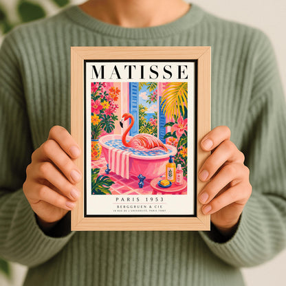 A vertical maximalist art print styled as a Henri Matisse exhibition poster. A vibrant pink flamingo with its long neck curved sits elegantly in a pink clawfoot bathtub. The bathroom features pink tiled floors and walls, with open blue shutters in the background looking out to the sea. The room is filled with tropical greenery and bright pink and orange flowers. A small pink table in the foreground holds soap and cosmetic bottles.