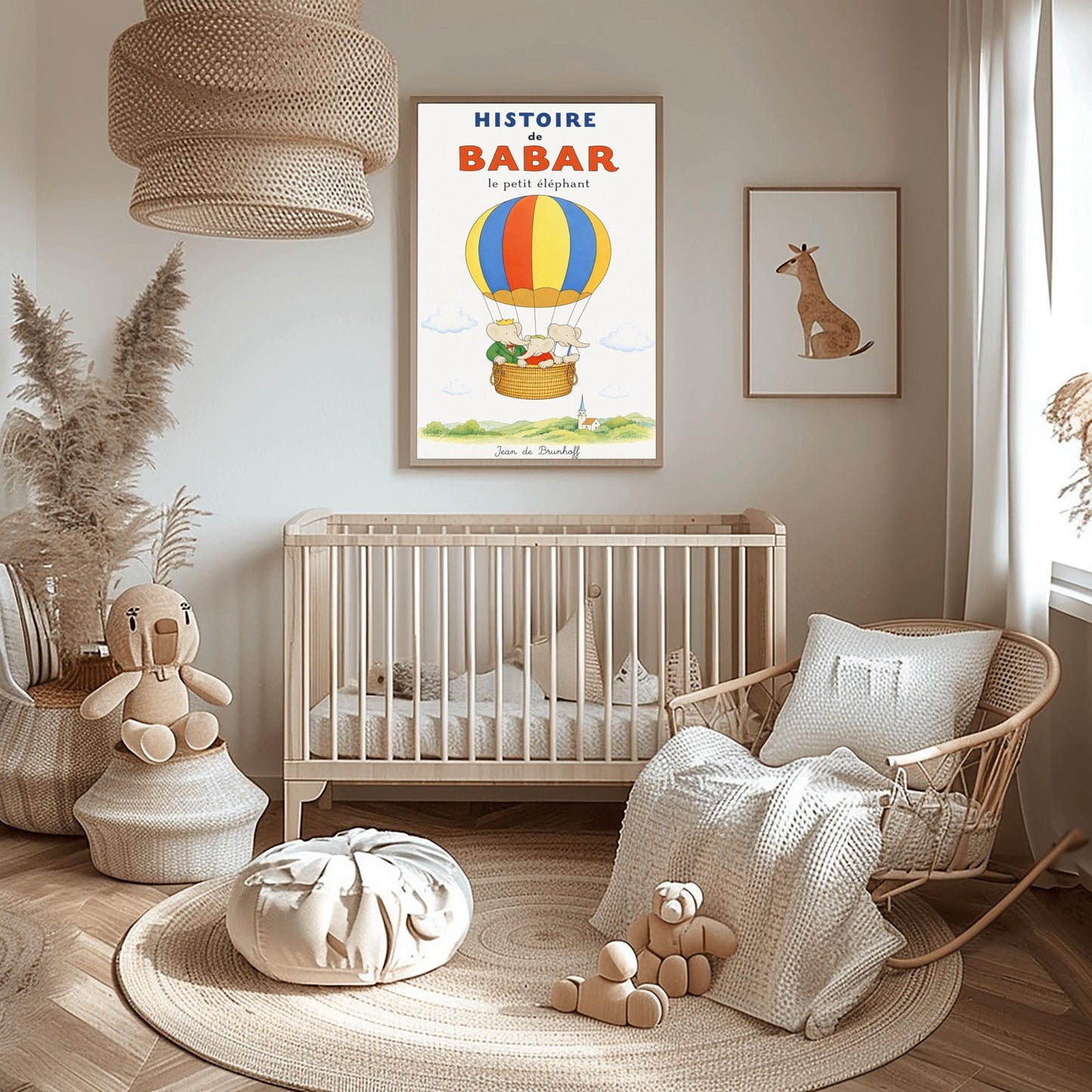 A vertical vintage-style storybook poster on an off-white background titled "HISTOIRE de BABAR le petit éléphant" in bold blue and orange font. The illustration features a large hot air balloon with yellow, blue, and orange stripes floating in a sky with soft clouds. Inside the wicker basket, three cartoon elephants ride together. On the left, King Babar wears a green suit and crown while pointing ahead. The other two young elephants wear red and white shirts.