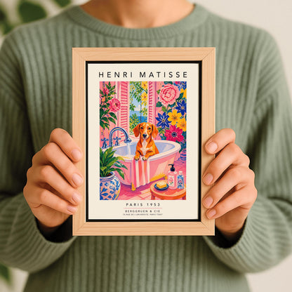 A vertical maximalist art print styled as a Henri Matisse exhibition poster. A brown Dachshund dog sits in a pink bathtub while water pours from a silver faucet. The room features vibrant pink walls and floors, decorated with very large pink, blue, and yellow flowers. A blue and white floral pot sits in the foreground along with a small stool holding soap and bottles. An open window in the background shows a blue sea and green leaves.