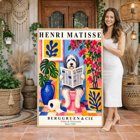 A vertical retro exhibition poster for Henri Matisse featuring a wide cream border. The central image shows a colorful Fauvism-style painting of a fluffy black-and-white Bearded Collie dog sitting on a pink toilet. The dog has shaggy fur and is looking forward while holding open a newspaper titled "LE JOURNAL DE PARIS". The background is a vibrant bathroom with a checkered mosaic floor, blue and yellow planters holding green monstera leaves