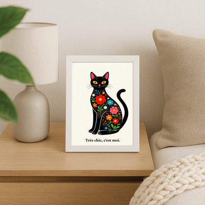A vertical minimalist art print of a sleek black cat sitting upright, facing forward. The cat's body is filled with colorful folk-art style flowers in red, blue, orange, and yellow with green leaves. The cat has large yellow eyes and a small pink nose. Below the cat, the French phrase "Très chic, c'est moi." is written in a black serif font. The entire image is set against a textured off-white background.