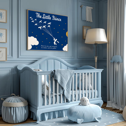A horizontal illustration of the Little Prince flying through a navy blue night sky. In the center, a white silhouette of the prince holds onto a cluster of fine strings attached to a flock of twelve white wild birds flying upwards and to the left. The sky is filled with small gold stars and features a large, textured gold circular moon on the right, with soft white clouds along the bottom edges