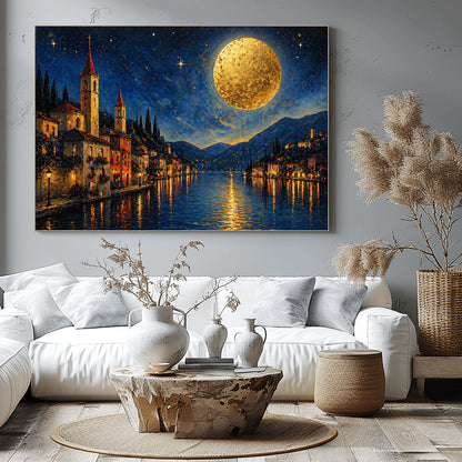 A horizontal art print in a decorative mosaic style inspired by Gustav Klimt. A charming lakeside village with warm-lit windows and tall church spires sits along the edge of dark blue water. A massive, glowing golden moon with heavy texture hangs in a starry night sky. The light from the moon and the town reflects in long, shimmering streaks on the water. The mountains in the distance are shaded in soft blues and purples.