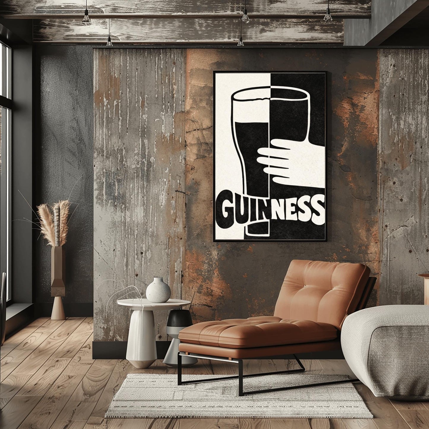 A vertical minimalist graphic split down the center: the left half is cream and the right half is black. A large Guinness pint in the center reverses its colors across the split. A white hand holds the glass from the right. The word "GUINNESS" at the bottom also reverses colors across the divide.