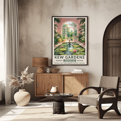 A vertical vintage travel poster for Kew Gardens. The scene is an interior view of a pink-walled conservatory featuring a long rectangular pond filled with lily pads and pink water lilies. A tiered stone fountain stands in the water. Large arched glass doors are open in the center, revealing a sun-drenched garden path lined with flowers and palm trees. The bottom features a cream border with bold green text: "KEW GARDENS" and "NEAREST UNDERGROUND STATION" with District Line details.
