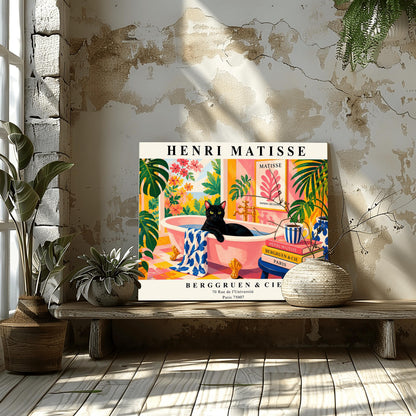 A horizontal art print designed as a Henri Matisse exhibition poster. A sleek black cat sits inside a pink clawfoot bathtub filled with water. The bathroom is vibrant with pink patterned walls, pink and yellow checkered tiles, and numerous large green Monstera plants. Outside the window is a bright garden with pink and orange flowers. A stack of art books and a striped mug sit on a blue stool in the foreground. The poster features bold black text at the top and bottom for "Henri Matisse"