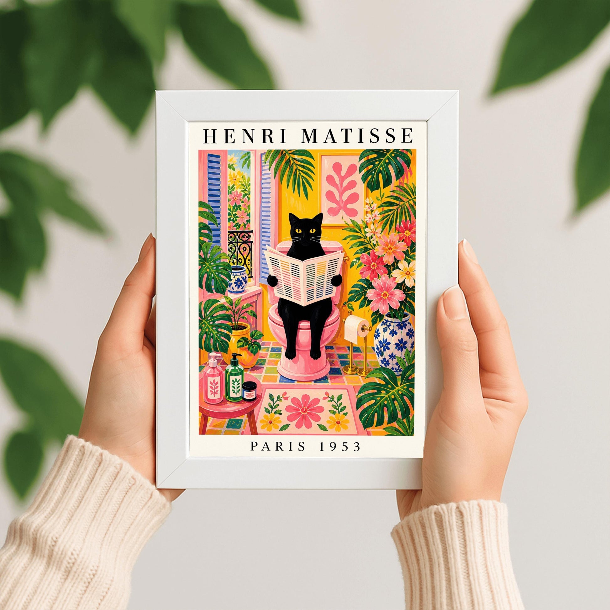 A vertical maximalist art print styled as a Henri Matisse exhibition poster. A sleek black cat with bright yellow eyes sits on a pink toilet, holding and reading a newspaper. The bathroom is filled with vibrant yellow walls, pink and yellow checkered tiles, and lush green monstera plants. A window with blue shutters looks out onto a garden. A pink bath mat and blue floral vases add more color. Bold black text at the top reads "HENRI MATISSE" and at the bottom "PARIS 1953".