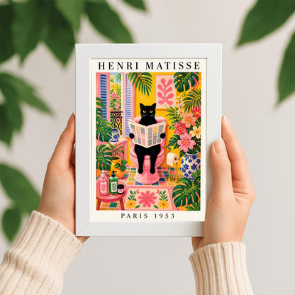 A vertical maximalist art print styled as a Henri Matisse exhibition poster. A sleek black cat with bright yellow eyes sits on a pink toilet, holding and reading a newspaper. The bathroom is filled with vibrant yellow walls, pink and yellow checkered tiles, and lush green monstera plants. A window with blue shutters looks out onto a garden. A pink bath mat and blue floral vases add more color. Bold black text at the top reads "HENRI MATISSE" and at the bottom "PARIS 1953".