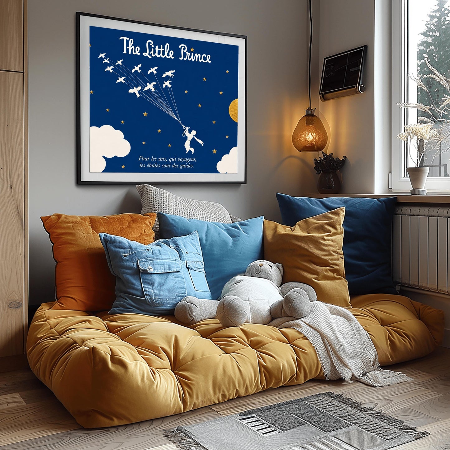 A horizontal illustration of the Little Prince flying through a navy blue night sky. In the center, a white silhouette of the prince holds onto a cluster of fine strings attached to a flock of twelve white wild birds flying upwards and to the left. The sky is filled with small gold stars and features a large, textured gold circular moon on the right, with soft white clouds along the bottom edges