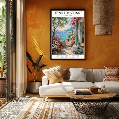 A vertical retro French exhibition poster for Henri Matisse Côte d'Azur on a wide ivory border, as seen in Screenshot 2026-06-06 at 23.18.59.png. The main image shows a beautiful summer illustration of a stone terrace overlooking the blue Mediterranean Sea where two white sailboats float. On the terrace, two women wearing white dresses and straw hats sit facing the water. To the left stands a green lemon tree with yellow fruit and large pots of pink and white flowers.