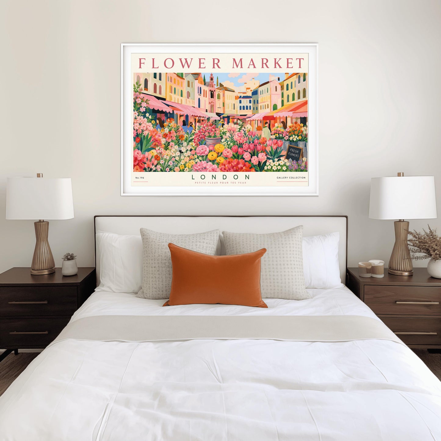 A vintage-style exhibition poster titled "FLOWER MARKET" at the top and "LONDON" at the bottom. The illustration depicts a vibrant open-air market scene packed with dense stalls of pink tulips, yellow ranunculus, and assorted green foliage. In the background, a row of colorful, multi-story pastel buildings stands under a light blue sky with soft white clouds, with shoppers walking between the stalls.
