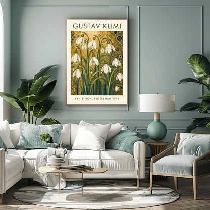 A vertical retro exhibition poster for Gustav Klimt featuring a wide cream-colored border. The central image shows an intricate Art Nouveau illustration of a cluster of delicate white snowdrop flowers with long green leaves reaching upward. The background is an opulent, decorative tapestry of metallic gold patterns, featuring detailed concentric circles, swirling spirals, and tiny mosaic tiles accented with hints of blue and teal.