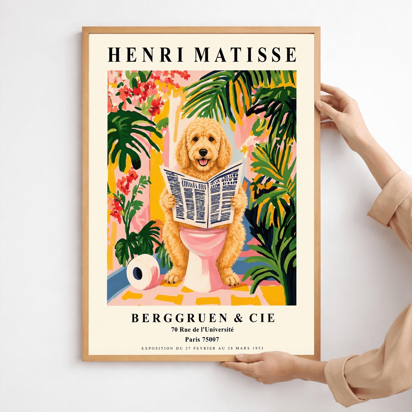 A vertical fine art exhibition poster in the style of Henri Matisse featuring a wide cream border. Bold black text reads "HENRI MATISSE" at the top and "BERGGRUEN & CIE" at the bottom. The central painting humorously shows a fluffy golden doodle dog sitting on a pink toilet while reading a newspaper, surrounded by vibrant green palm leaves, tropical flowers, and a toilet paper roll on the floor.