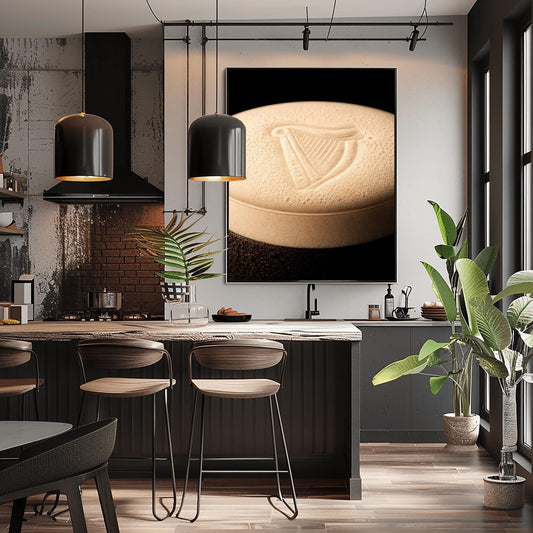 A vertical macro photograph of the thick, creamy foam head on a pint of Guinness. The iconic Guinness harp is embossed into the center of the velvety bubbles. The image features warm cream tones against a dark, shadowy background.
