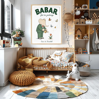 A vertical fine art exhibition poster featuring a classic illustration of Babar the Elephant by Jean de Brunhoff. Set within a wide white border on a textured off-white background, the elephant is shown in a green suit and red bowtie watering a red tulip with a gold can. Four butterflies fly nearby, leaving a dotted line that forms a heart shape. Bold green text at the top reads "BABAR fait du jardinage".