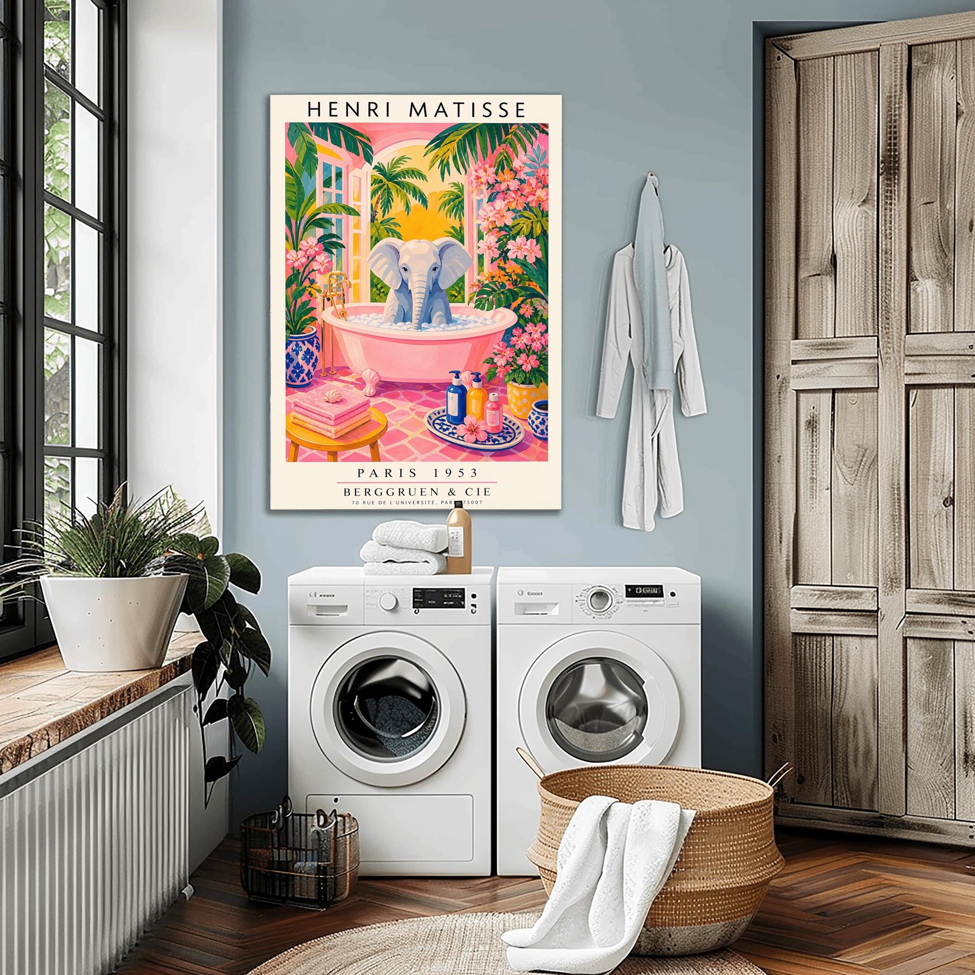 A vertical maximalist art print styled as a Henri Matisse exhibition poster. A light grey baby elephant is sitting in a large pink clawfoot bathtub filled with white bubbles. The bathroom features hot pink tiled floors, vibrant pink flowers, and lush green tropical plants. In the background, an arched window shows a bright golden sunset with palm tree silhouettes. A small yellow stool with towels and various blue and yellow ceramic vases decorate the room.