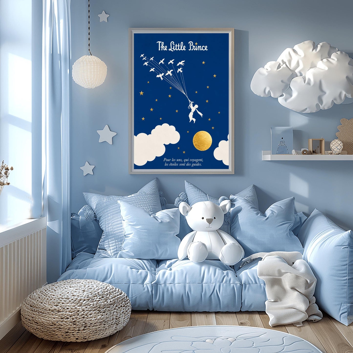 A vertical art print with a deep indigo blue background. A small white silhouette of a boy, the Little Prince, is being pulled upward by a flock of white birds on long strings. The sky is filled with small gold stars and large white clouds at the bottom, next to a textured gold moon. The title "The Little Prince" is at the top in white script, and a French quote is at the bottom in white italics.