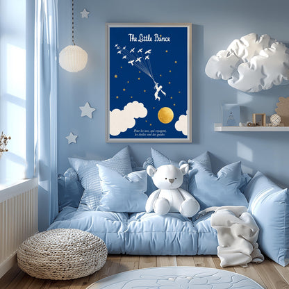A vertical art print with a deep indigo blue background. A small white silhouette of a boy, the Little Prince, is being pulled upward by a flock of white birds on long strings. The sky is filled with small gold stars and large white clouds at the bottom, next to a textured gold moon. The title "The Little Prince" is at the top in white script, and a French quote is at the bottom in white italics.