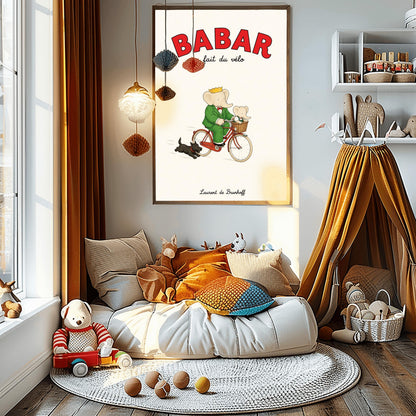A vertical retro fine art exhibition poster titled "BABAR fait du vélo" on a wide cream border. The top "BABAR" text is printed in a bold red font. The illustration shows an elephant wearing a crown and green suit riding a vintage red bicycle. A smaller baby elephant is sitting inside a brown wicker basket on the handlebars, and a small black dog runs along beside the bike. The name "Laurent de Brunhoff" anchors the bottom.