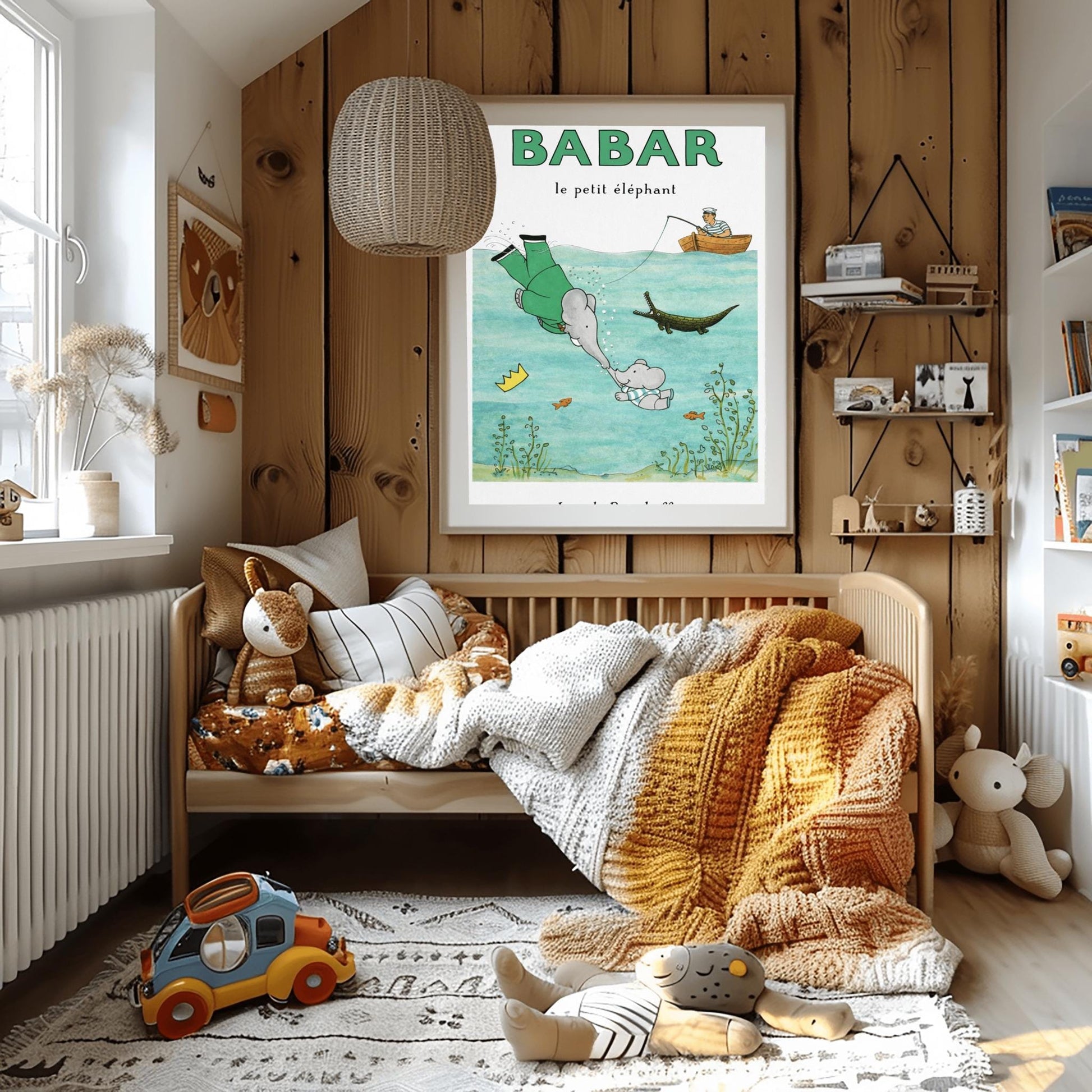 A vertical children's illustration poster titled "BABAR le petit éléphant" at the top in green. The scene shows King Babar in a green suit diving underwater to touch trunks with a small elephant calf. His golden crown floats nearby. Above the water, a man in a striped shirt sits in a rowboat fishing. A crocodile and several small orange fish swim in the water among green aquatic plants. The name "Jean de Brunhoff" is at the bottom.